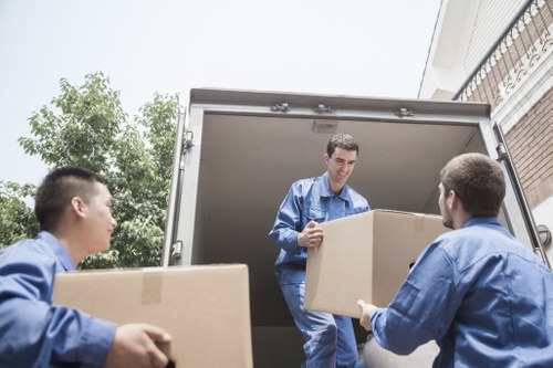 Professional movers handling office equipment in central London